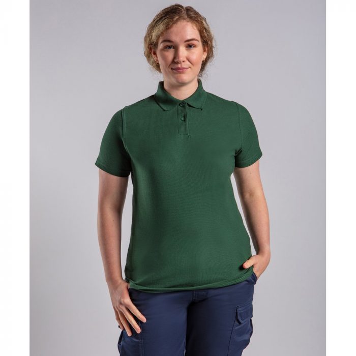 A woman modelling a green polo shirt.
